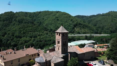 aerial establishing shot above espinelves old valley green countryside town in catalonia spain during daylight summer, traditional architecture