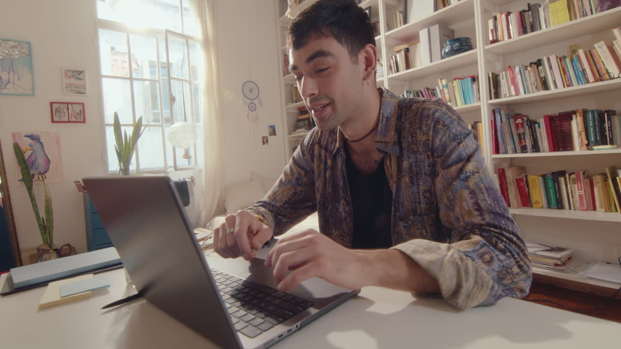 Young Man Video Calling on Laptop at Home