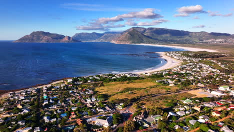 south african windy kommetjie lighthouse seaside port town drone aerial cinematic mid day afternoon cape town noordhoek chapman peak stunning spring summer deep aqua blue ocean forward pan up motion