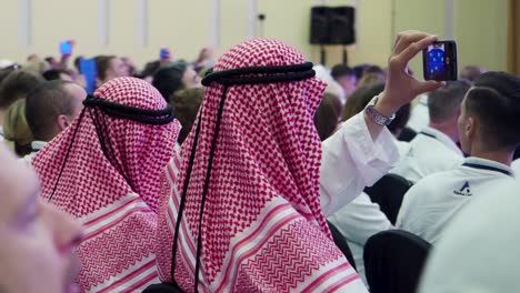 people taking selfies at a conference