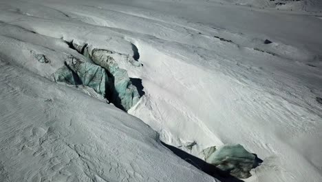 blue glacier with visible crevices in the swiss alps, saas fee