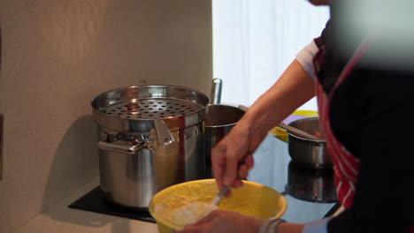 woman in the kitchen preparing traditional dish for the family. close up
