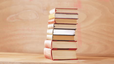 animation of stack of books over mathematical equations and formulae