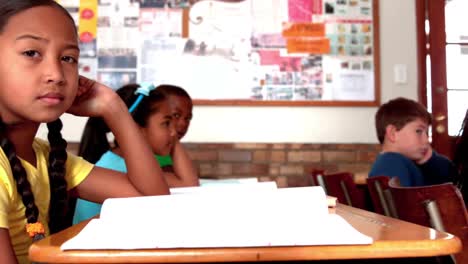 Cute-little-girl-smiling-at-camera-during-class