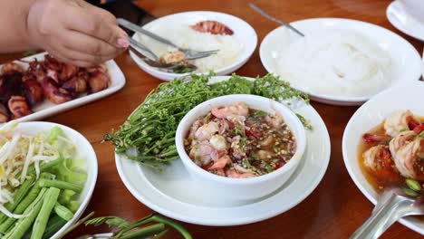 hands assembling ingredients in a bowl