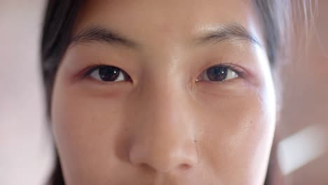 Close-up-portrait-of-opening-eyes-of-casual-asian-businesswoman,-slow-motion