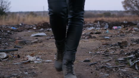 Close-up-of-women's-feet-walking-through-dumpsite