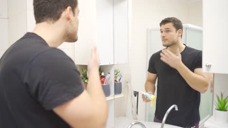 young man applying cream to his skin.