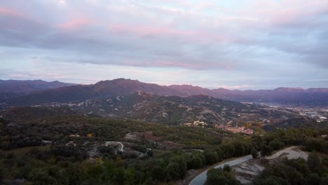 drone fly close to the trees of a pyrenees mountains in sunset