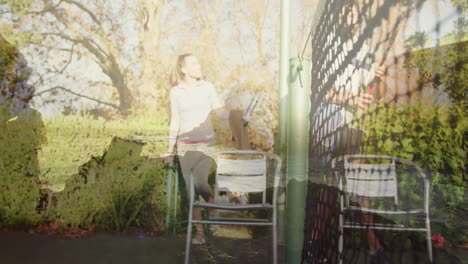 walking with tennis racket near court, woman in sunlight through trees