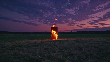 burning door in a field at sunset