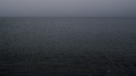 surface of water on grey misty day