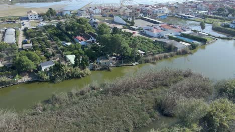 aerial view of a canal town with gardens and people