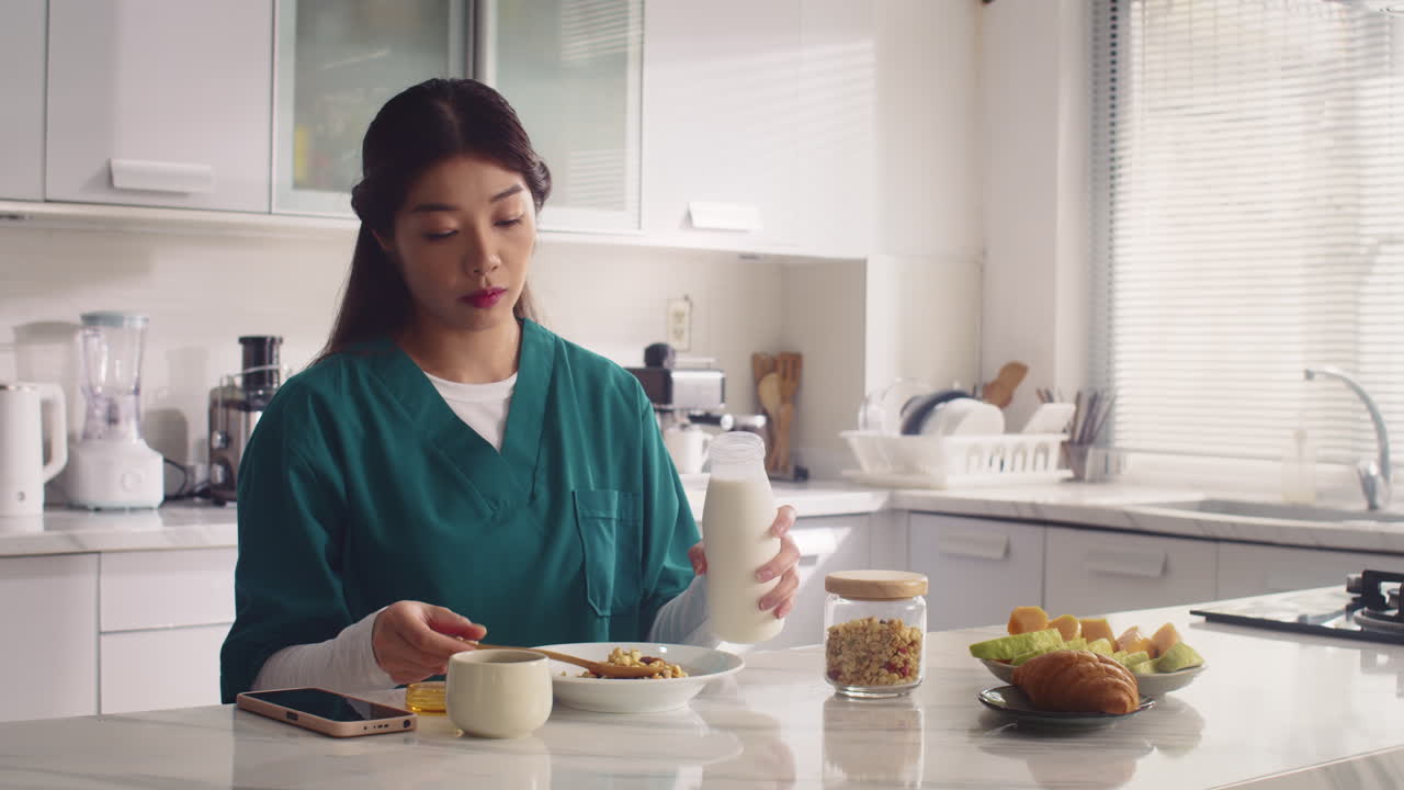 Young Nurse Having Breakfast with Muesli before Work
