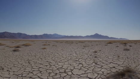 desert landscape with cracked earth and mountains