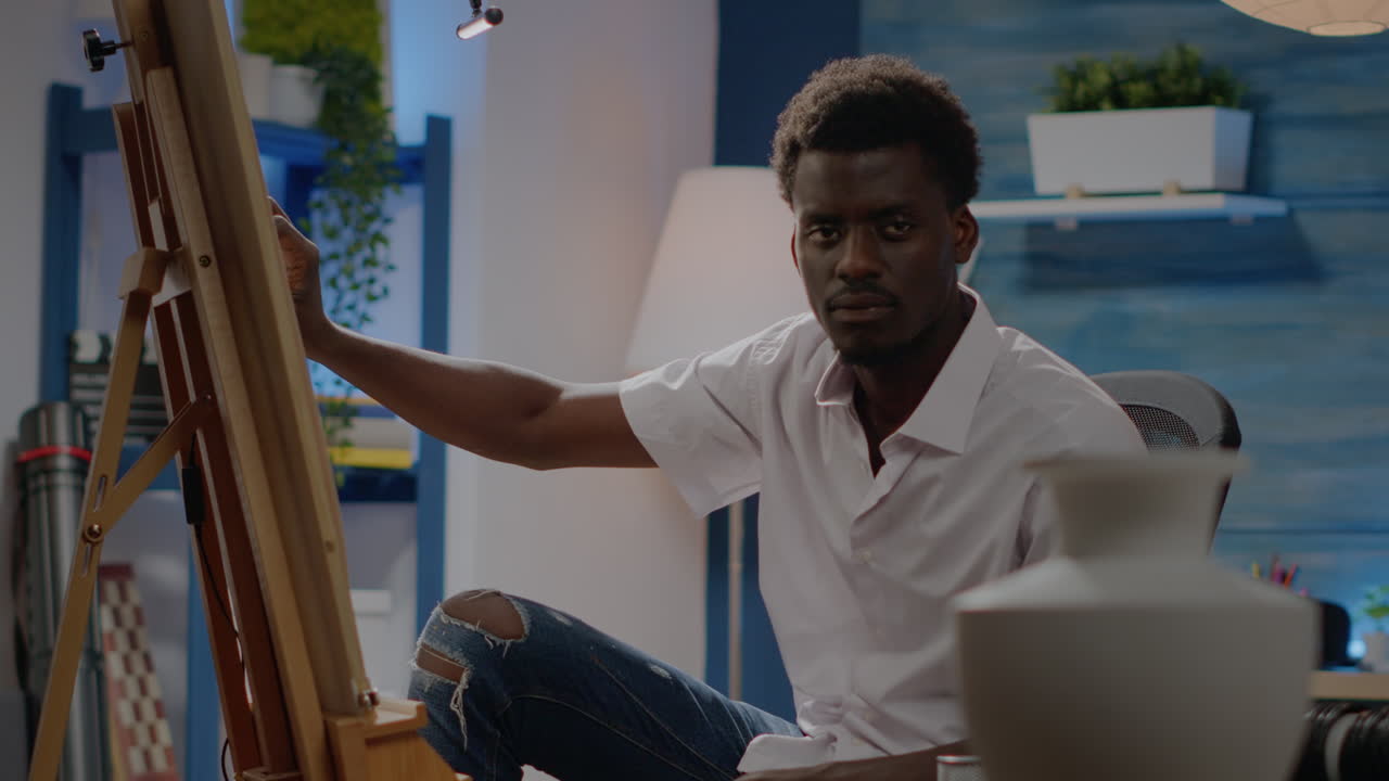 Artist of african american ethnicity drawing vase design