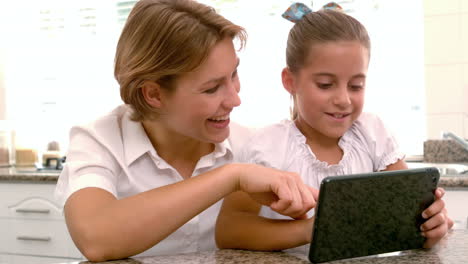 happy mother and daughter using tablet pc together