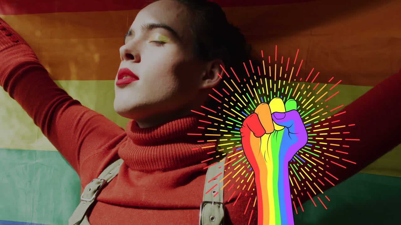 Raising rainbow-colored fist animation over person standing in front of pride flag