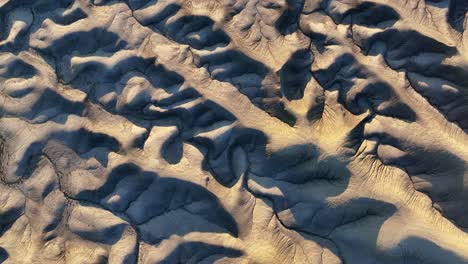Lights-and-shadows-play-over-the-riverbeds-and-hills-near-Hanksville,-Utah