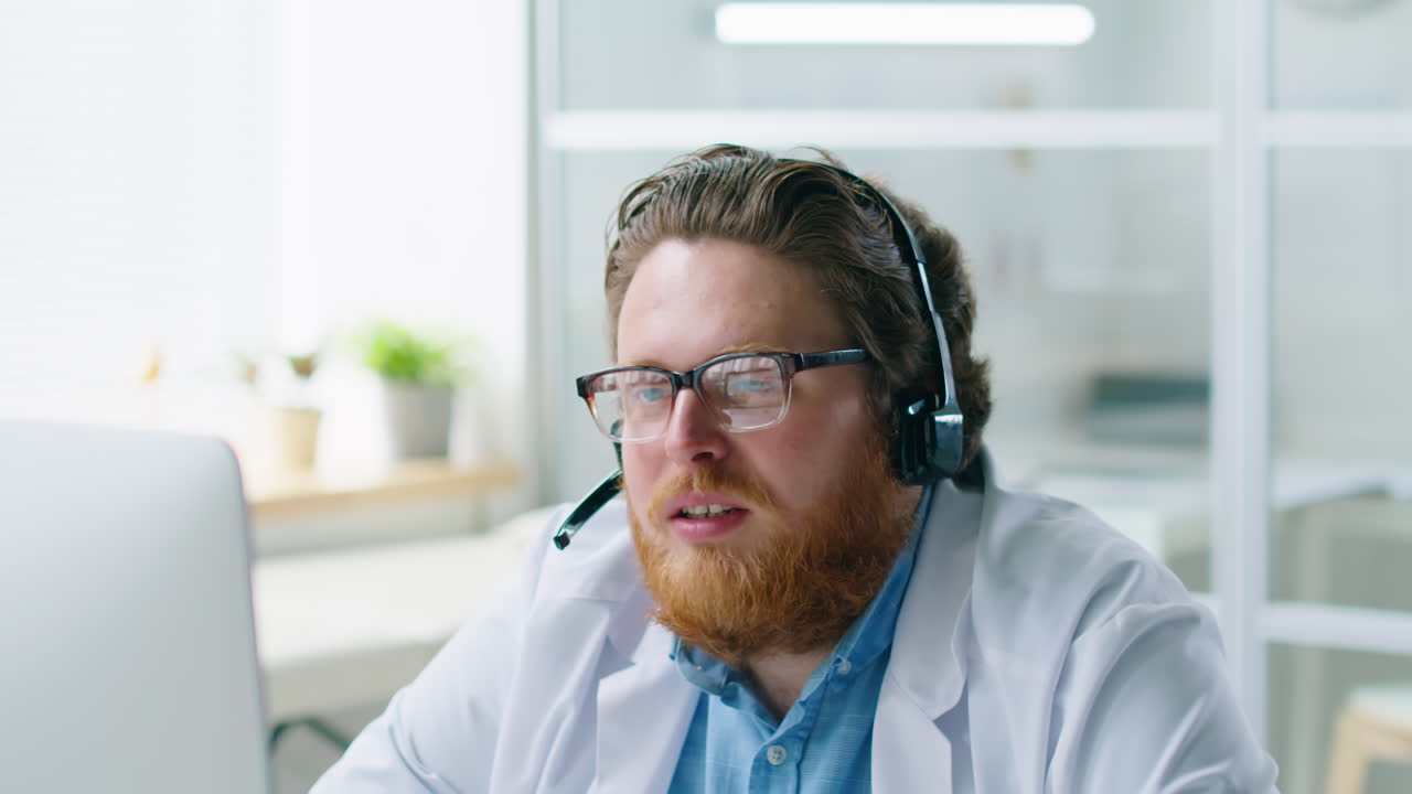 Male Doctor in Headset Giving Online Consultation