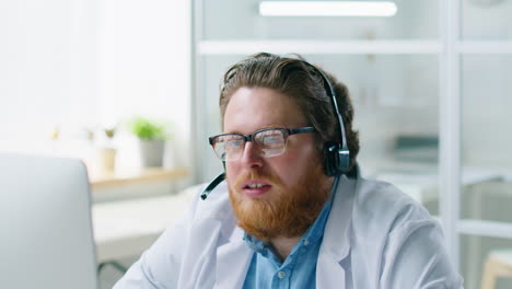 male doctor in headset giving online consultation