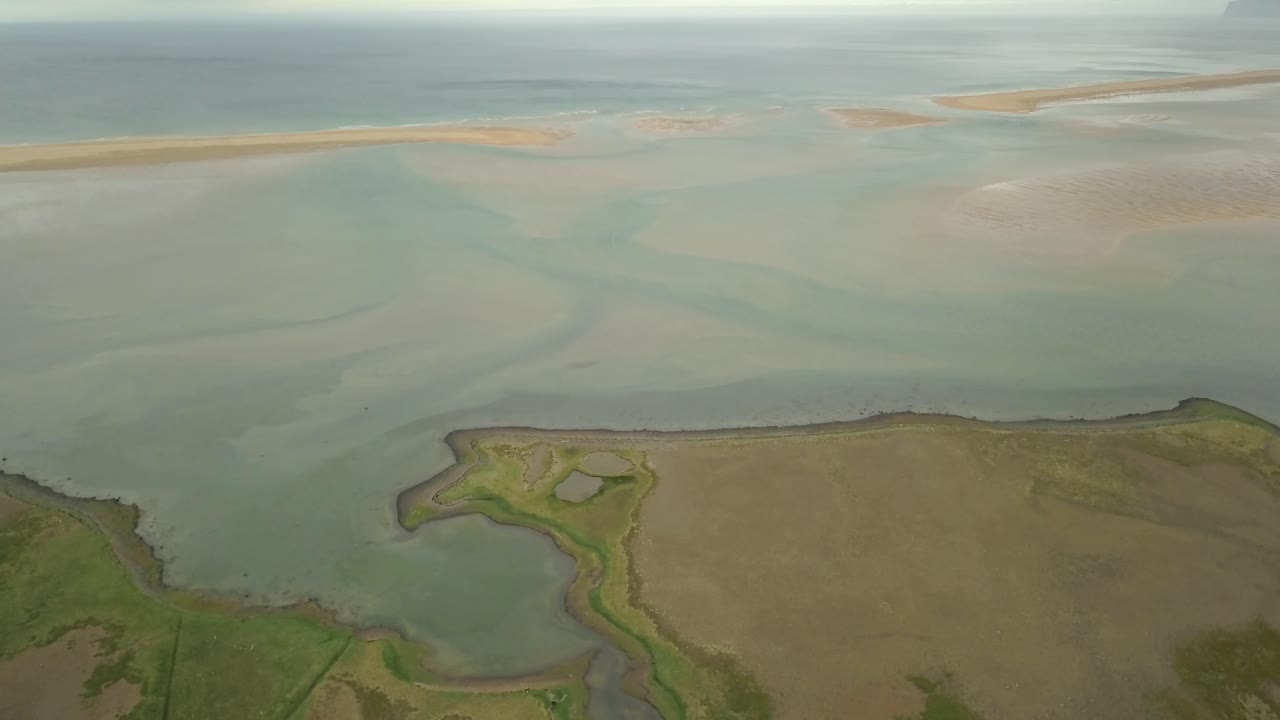 Aerial view of a tidal estuary with sandbars and currents