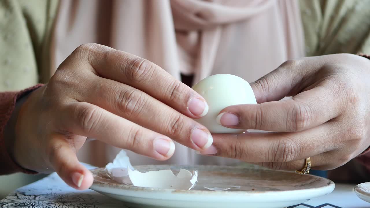 Woman Peeling a Hard-Boiled Egg