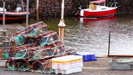 red boat near fishing gear in harbor