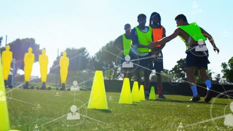 animation of network of connections with people icons over football players practicing