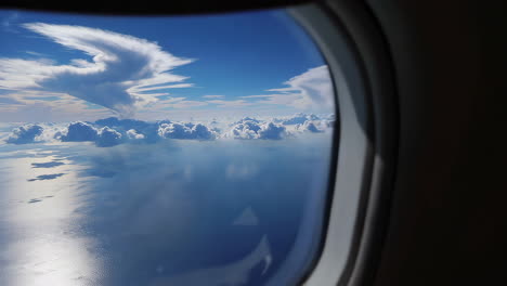 airplane window view of clouds over ocean