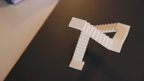 Foam-Architecture-Model-Staircase-Sitting-on-Brown-Desk,-Overhead-view-Pan-right