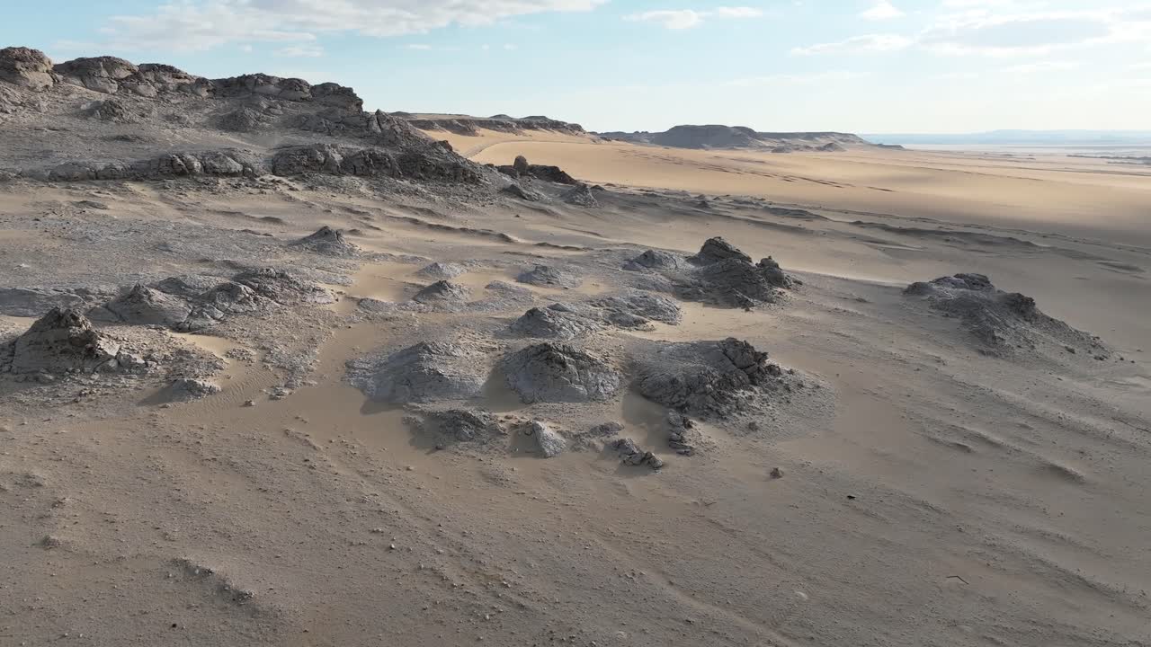Contrasting Desert Landscape: Sand and Rocky Outcrops