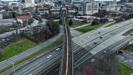 hyperlapse shot of traffic on highway and crossing train on bridge in atlanta