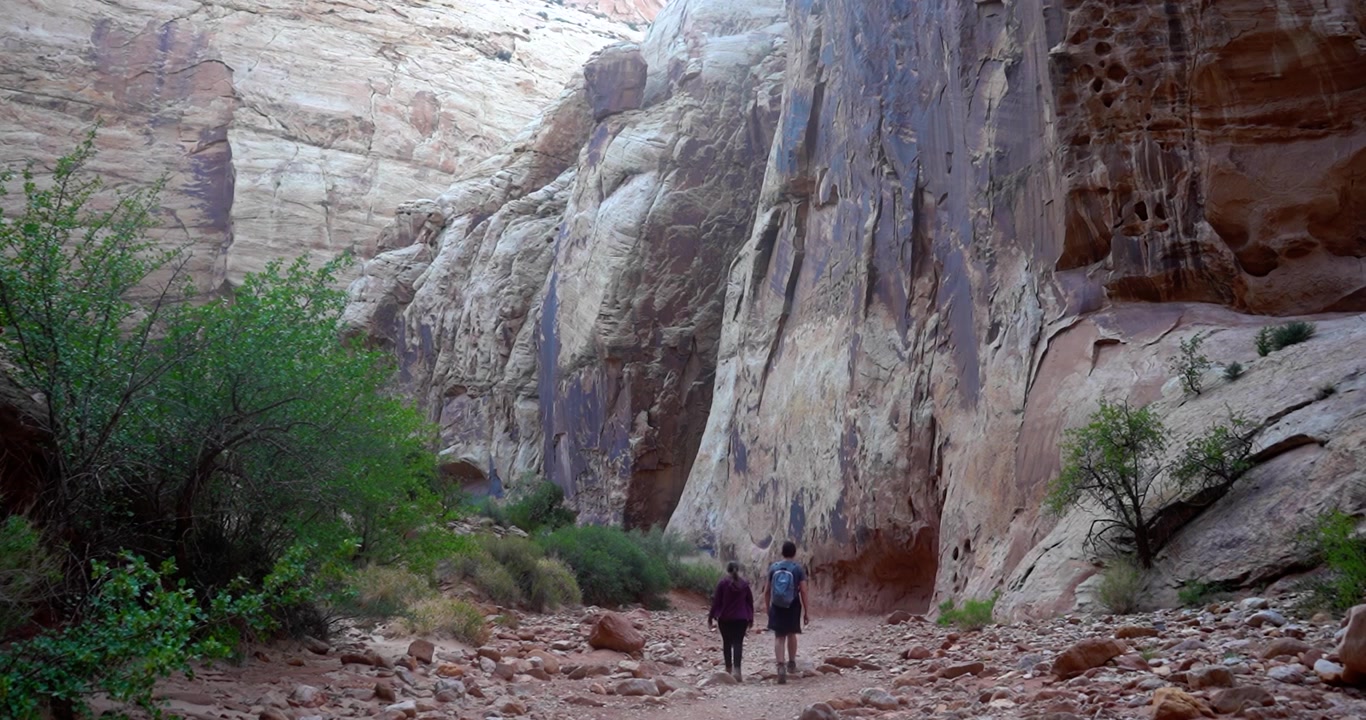Pareja caminando por un sendero de senderismo en el Parque Nacional Capitol Reef, Utah