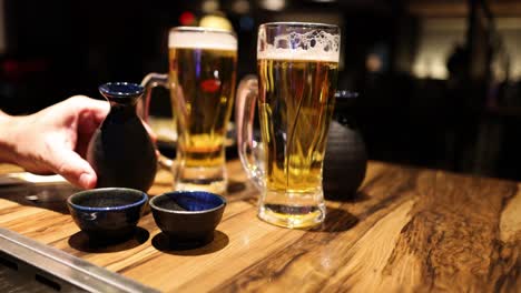 sequence of sake being poured into cups