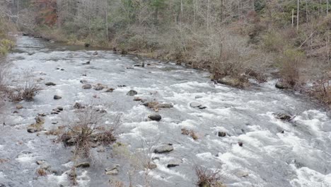 drone shot of river low altitude flying upstream in late fall in western north carolina