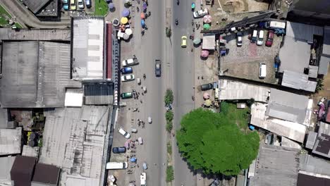 aerial view over streets and a traffic circle in sunny douala city, cameroon, africa - top down, drone shot