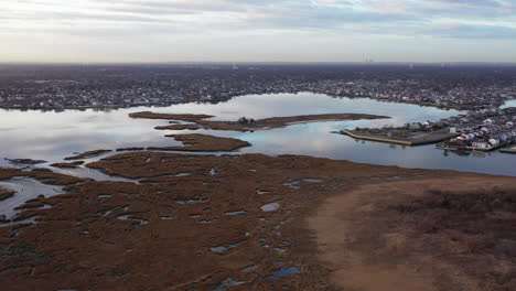 an aerial shot over baldwin bay near freeport, ny on a cloudy evening