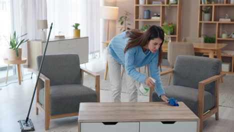 woman cleaning a table in a living room