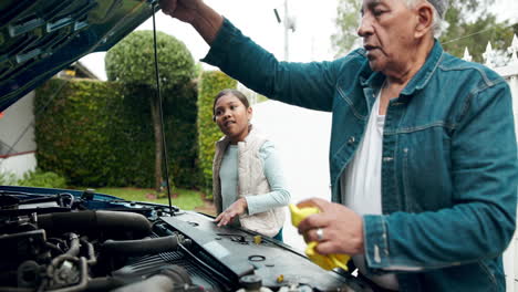 grandfather and granddaughter working on car