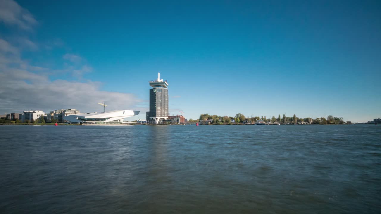 Timelapse video of ferries arriving and departing on the IJ river, next to the Central Railway station of Amsterdam, the Netherlands