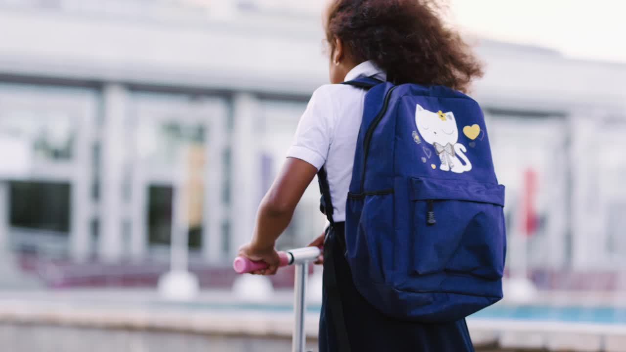 Girl riding scooter to school