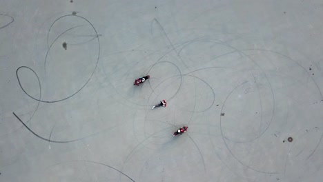 biker riding around girl. aerial drone shot of motorcycle riding in the middle of parking