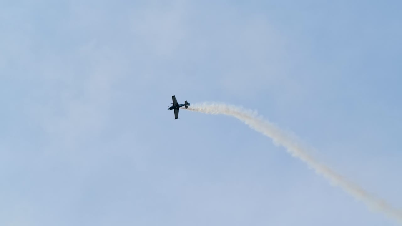 Propeller Stunt Plane Flying Aerobatics with Smoke Trail