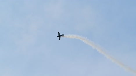 propeller stunt plane flying aerobatics with smoke trail