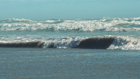 sea waves receding on beach creating backwash