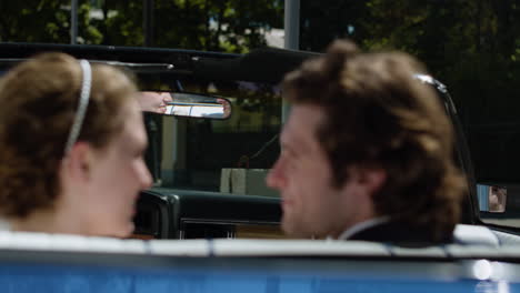 Just-married-couple-in-a-blue-convertible-car