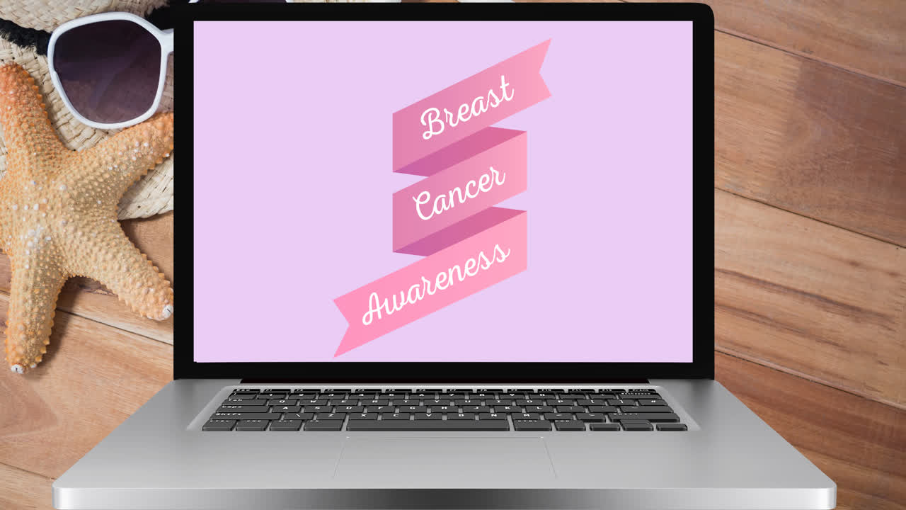 animación del texto de cáncer de mama rosa en la pantalla de una computadora portátil