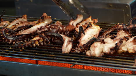 grilling pieces of squid in a market