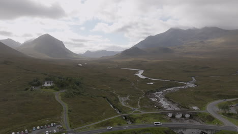 Marsco-Mountain-and-Sgurr-nan-Gillean-aerial-shot-push-in-over-the-river-and-marshland